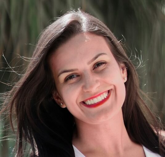 Photo by Rodrigo Rodrigues | WOLF Λ R T woman in white halter top smiling